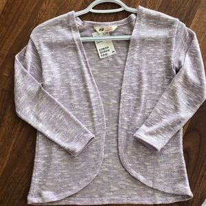 Girl’s purple and white light sweater